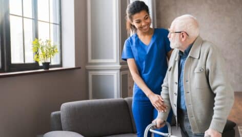 AHome nurse helping an elderly man