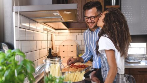 Couple cooking a meal in a rented AirBNB