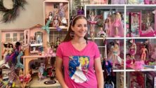 Ilana Volain in front of her barbie collection