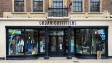 Man waits in front of Urban Outfitters in Cambridge city center.