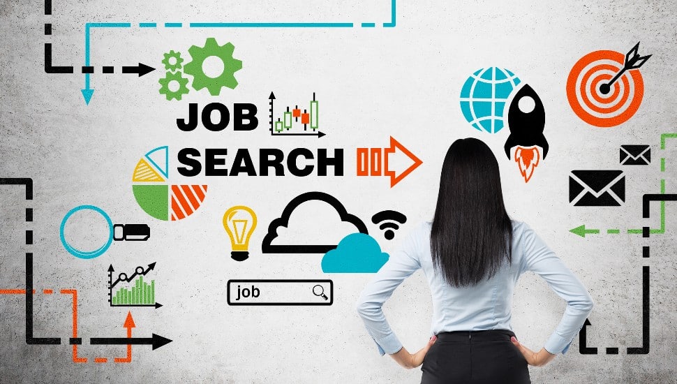Rear view of the brunette woman who is looking at the wall with colourful icons about job vacancies.