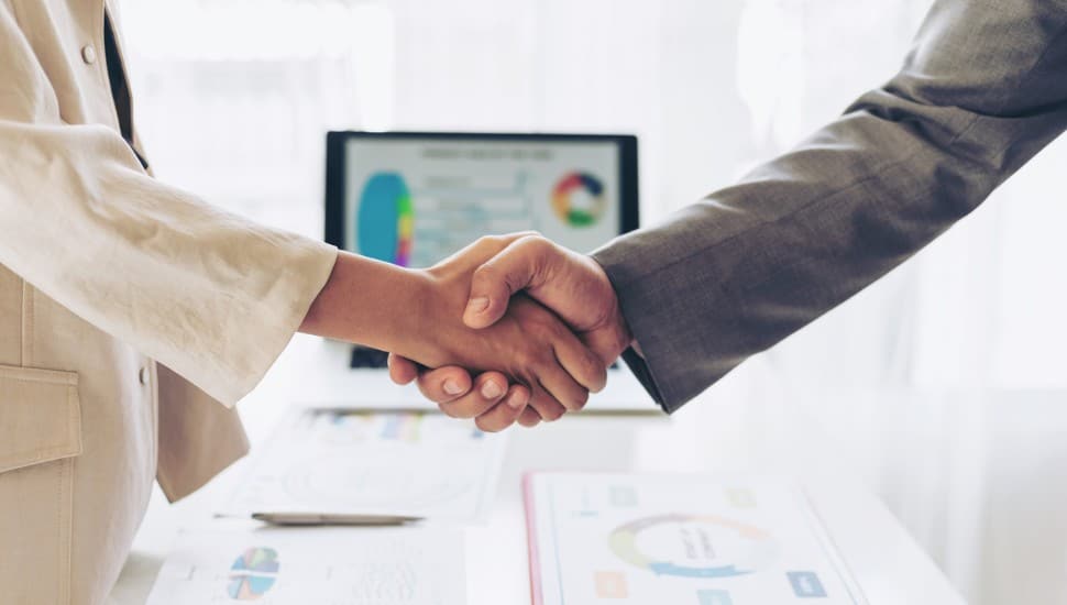 close up hand of business people shaking hands finishing up meeting