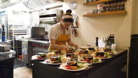 Amanda Shulman prepares a meal at Her Place Dinner Club