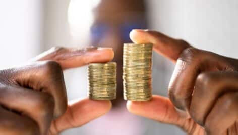 Man holding two coin stacks