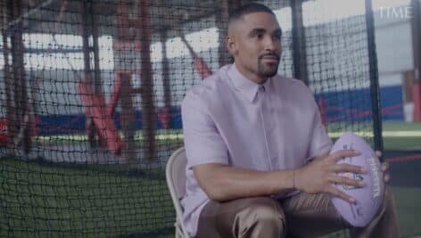 Jalen Hurts Sitting in makeshift football field holding football