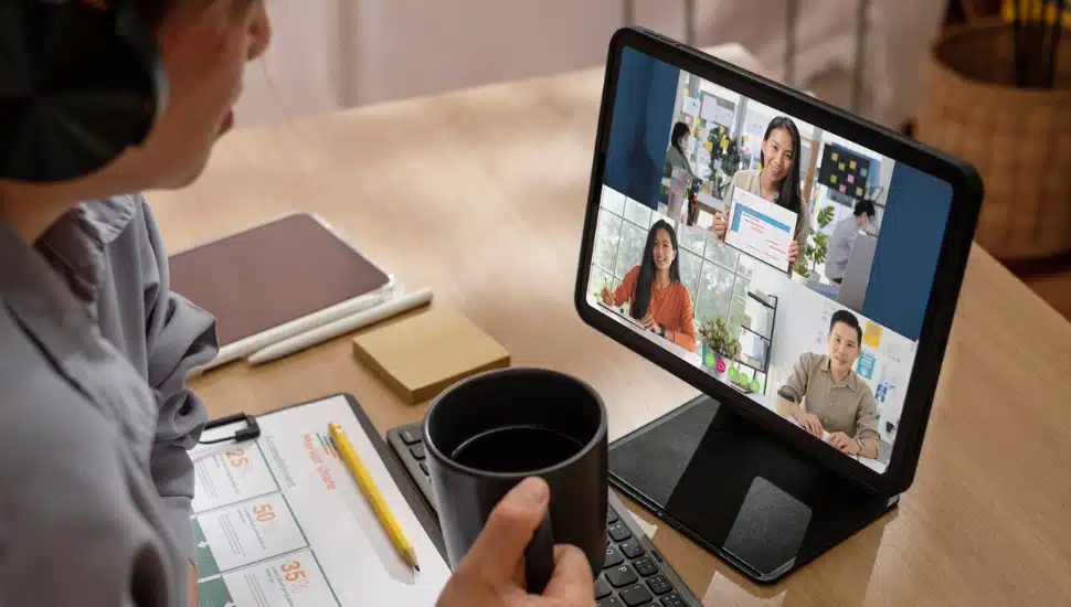 Young man working remotely on a zoom meeting