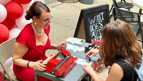 Sheryl Oring sitting at her typewriter in Center City