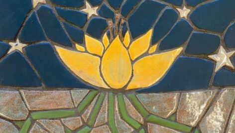 mosaic depicting flower, roots, and stars