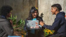 Penn State Abington Students sitting outside with laptops smiling