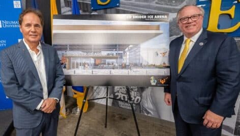 Gathered around a rendering of the Ed Snider Ice Arena are Scott Tharp, president and CEO of Ed Snider Youth Hockey & Education, and Dr. Chris Domes, Neumann University president.