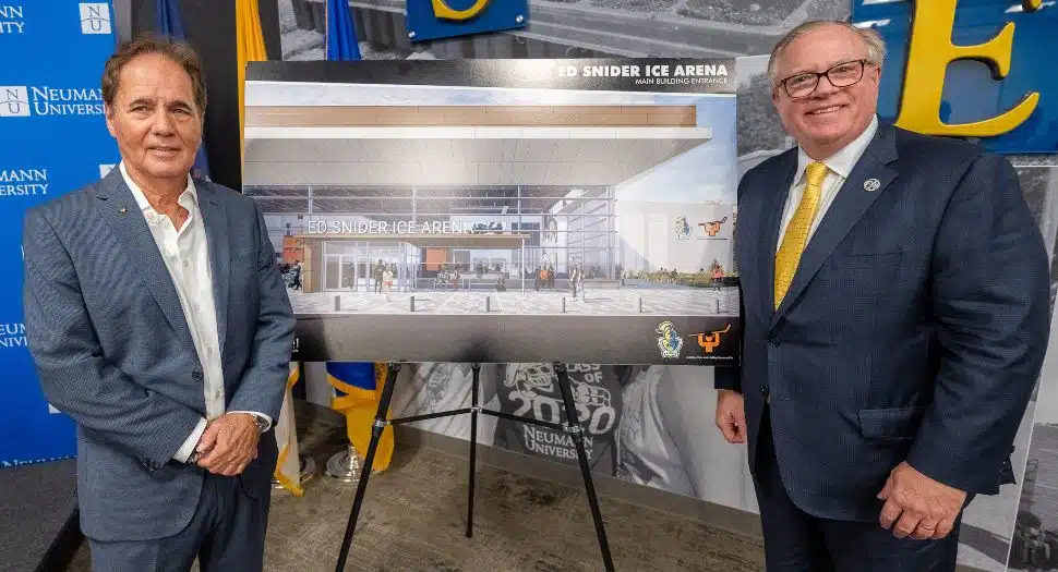 Gathered around a rendering of the Ed Snider Ice Arena are Scott Tharp, president and CEO of Ed Snider Youth Hockey & Education, and Dr. Chris Domes, Neumann University president.