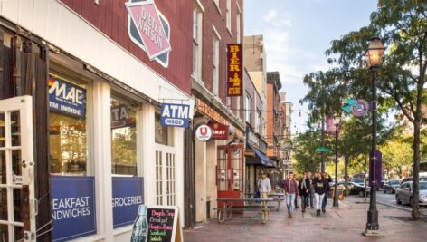 Street view along landmark Market Street in Old City Philadelphia, PA with people in view. Old City is well known for it's many historical sites.