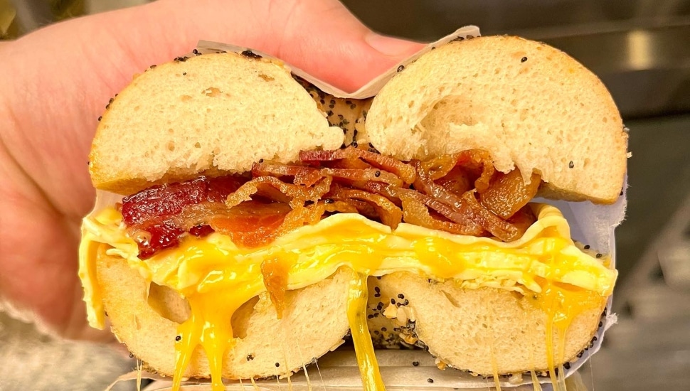 A bagel with egg, bacon, cheese