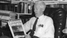 Photographer Robert S. Halvey reading a book on photography.