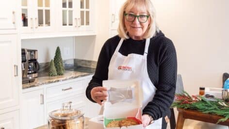 Donna Kelce holding box of her famous cookies