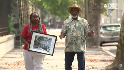 Learley McAllister holds framed photo of the family outside Girard College during 1965 Martin Luther King Jr. speech