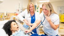 Neumann University's Dr. Kristen Evans works with a nursing student.