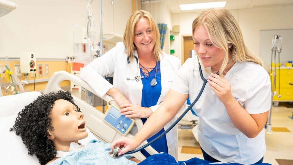 Neumann University's Dr. Kristen Evans works with a nursing student.