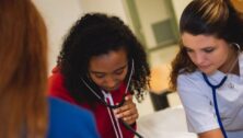 two college nursing students with stethoscopes