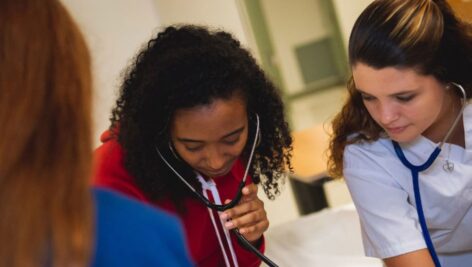 two college nursing students with stethoscopes