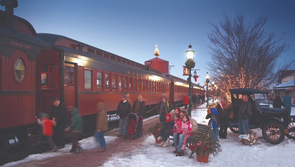 parked train in the evening at Strasburg rail road station with snow and garlands