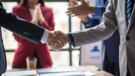 two business people shaking hands, deal being made