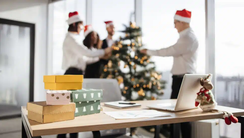 Presents on a desk with employees in the background