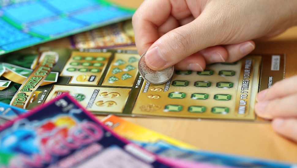 Man scratching off a lottery ticket