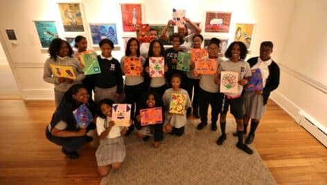 Children holding works of art at Woodmere Art Museum.