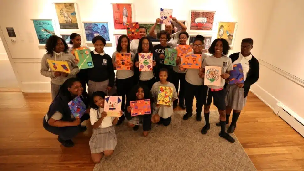 Children holding works of art at Woodmere Art Museum.
