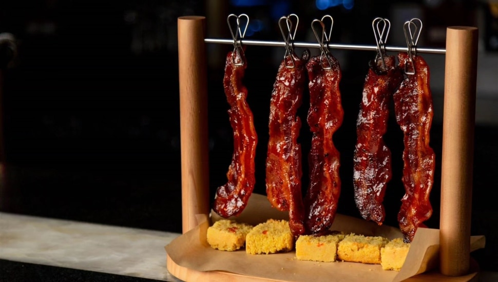 Bacon dangling over cornbread