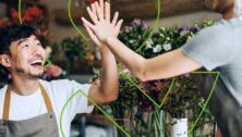 man smiling giving high-five