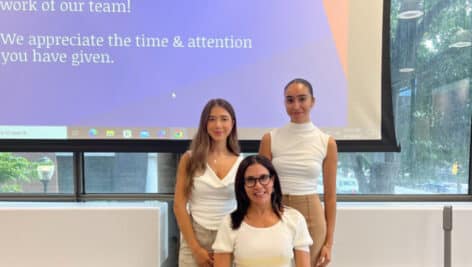 Wharton students Sindi Banaj (left) and Maryem Bouatlaoui (right) with Gillian Bazelon (seated), Wharton senior associate director.