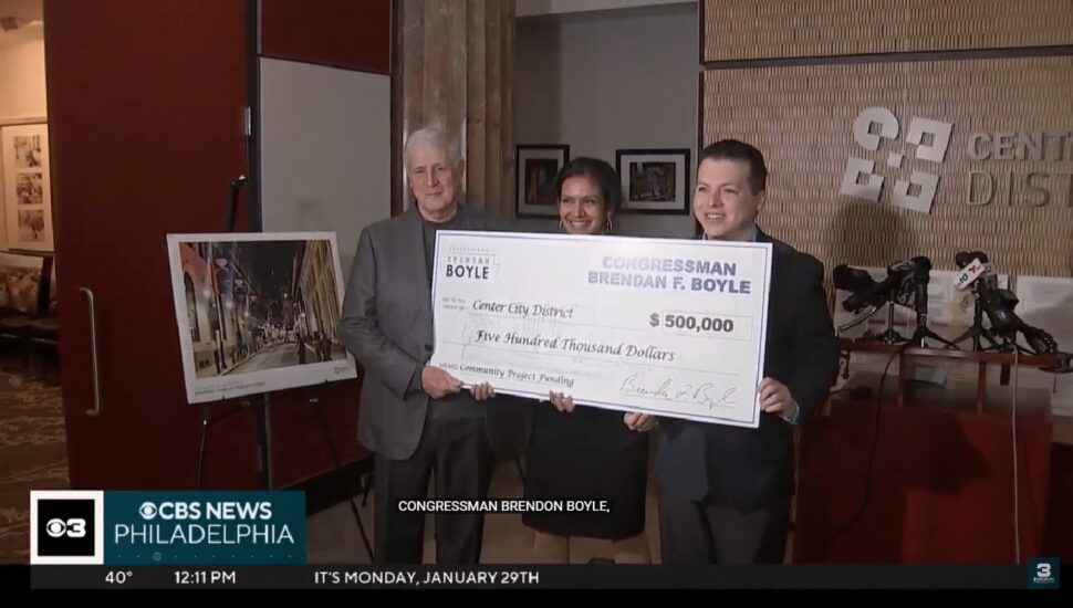 Paul Levy, Prema Katari Gupta, and Paul Levy hold large check