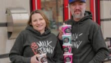 Two people holding containers of Milk Jawn ice cream