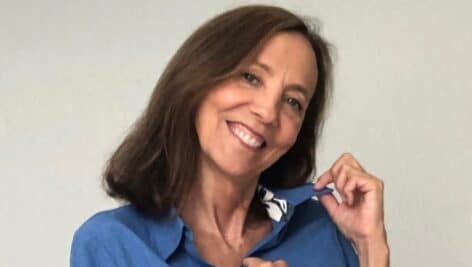 Woman poses with blue blouse