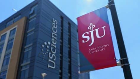 Exterior of USciences with St. Joseph's University flag