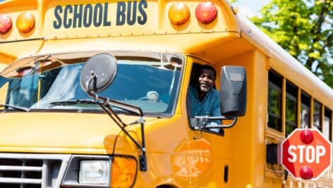 School bus driver looking at camera through window