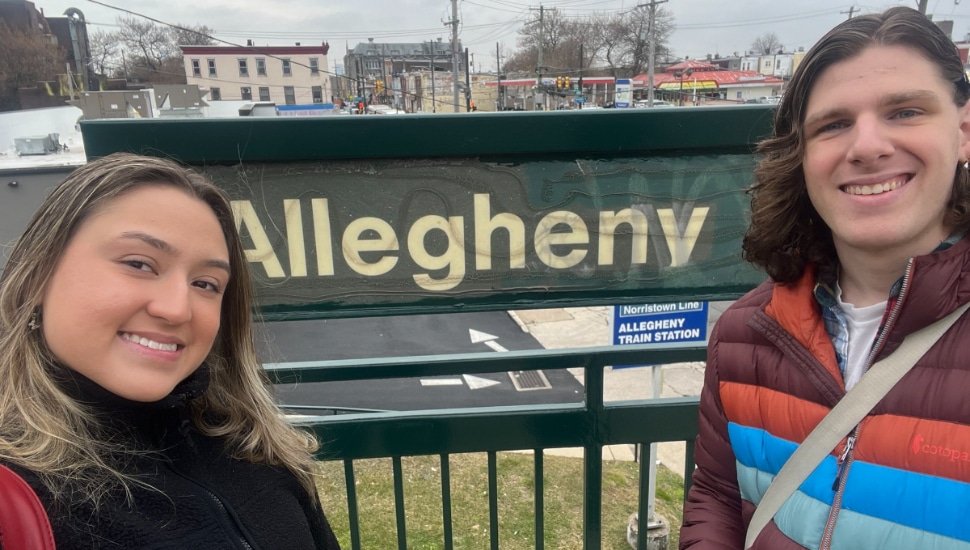 Two people waiting outside Allegheny Train Station