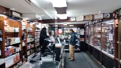 Customers and employees inside Northeast Philly headshop, Artifax, during one of its final days in businesses.