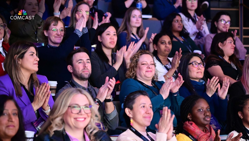 People clapping at a Comcast event