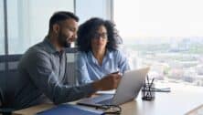 Man coaching a young woman in an office