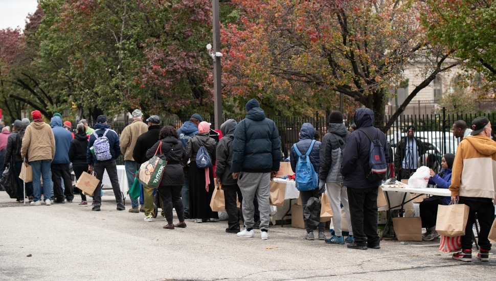 Line of in-need people collecting necessities