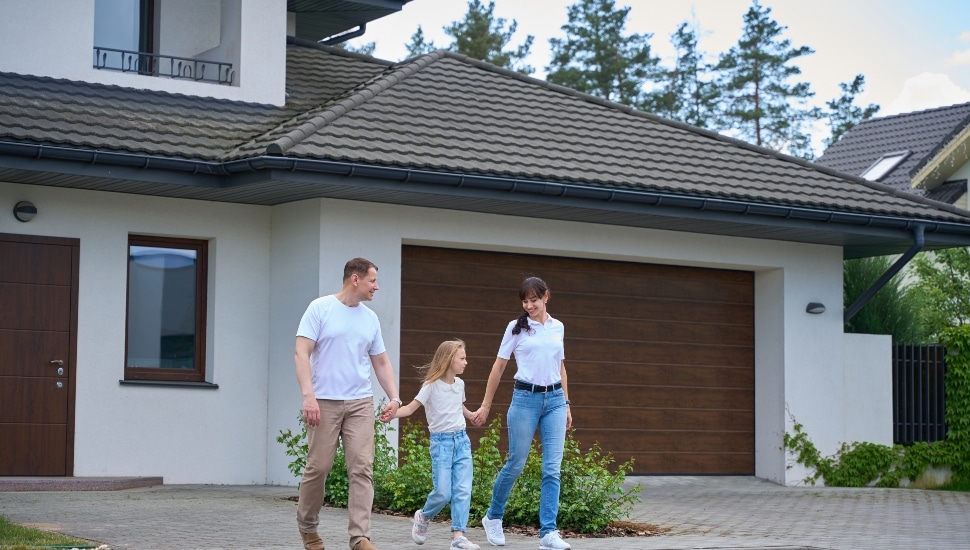 Young family in front of house.