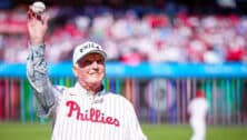 Charlie Manuel in a Phillies uniform with a baseball on the mound