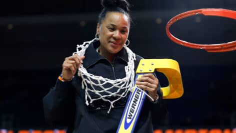 Dawn Staley smiles after cutting down the net