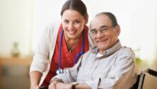 A nursing attendant poses for a photo with a resident of Freedom Village at Brandywine.