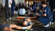 A nursing student works in the dark in Latham Hall on campus providing triage and first aid during the Widener disaster drill that simulated a tornado hitting the campus.