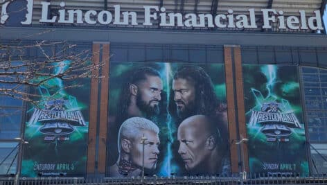 A Wrestlemania sign and poster outside Lincoln Financial Field