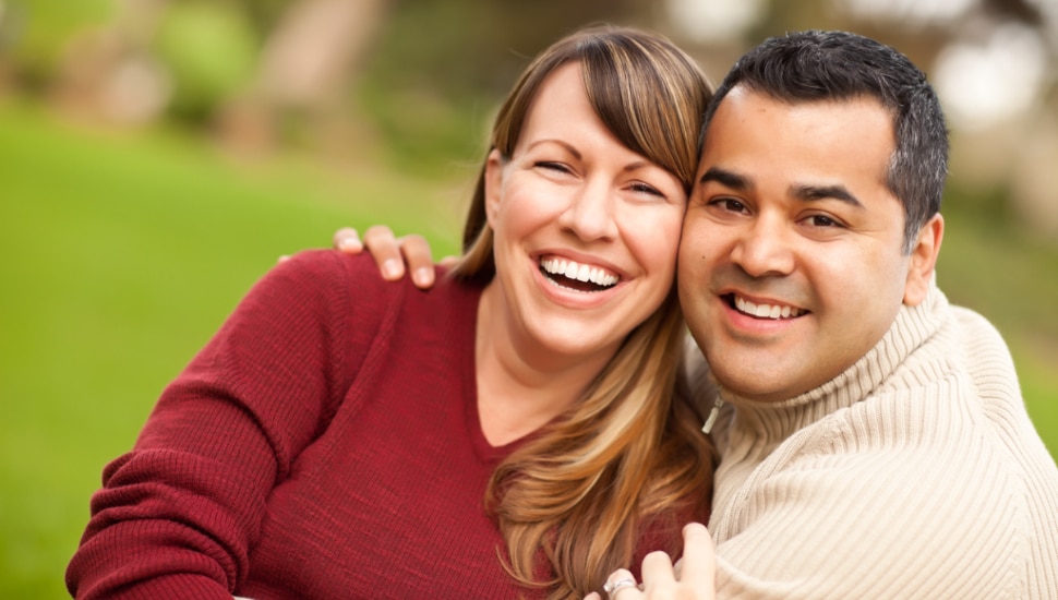 A couple smiling for the camera.